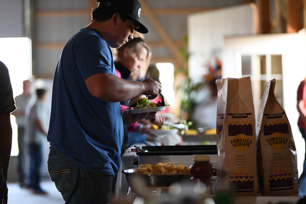 Person preparing food at a buffet in Montana.