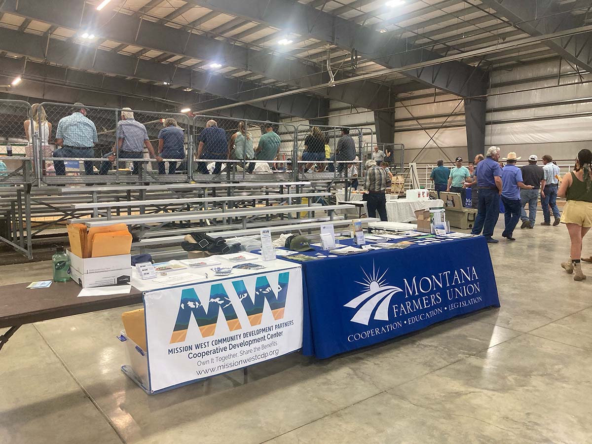 Montana Farmers Union event with attendees in a large indoor arena.